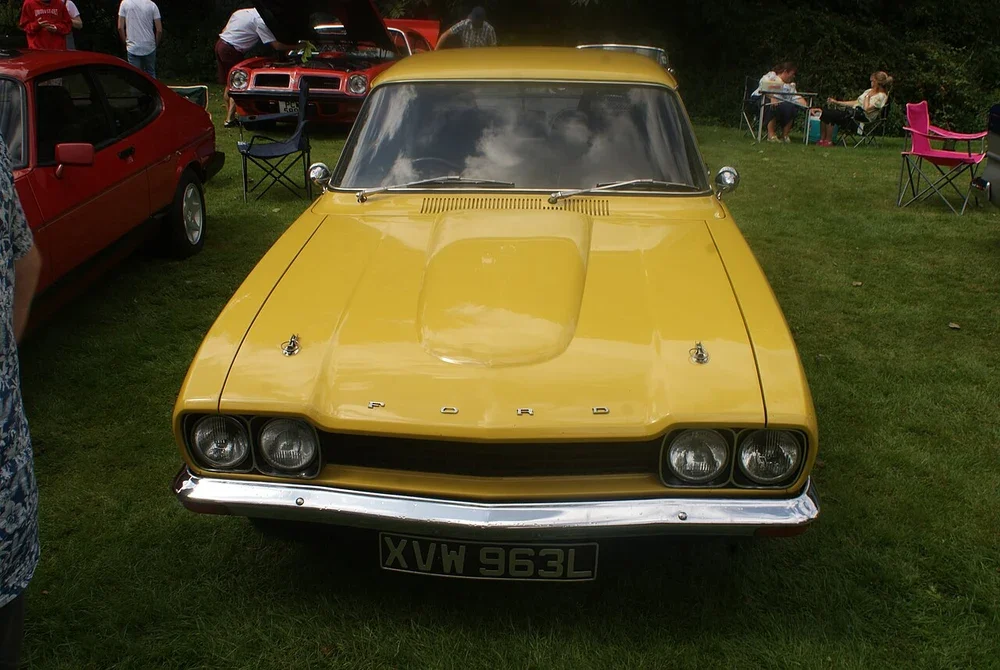 Yellow classic coupé displayed at the Hedingham Castle car show in England