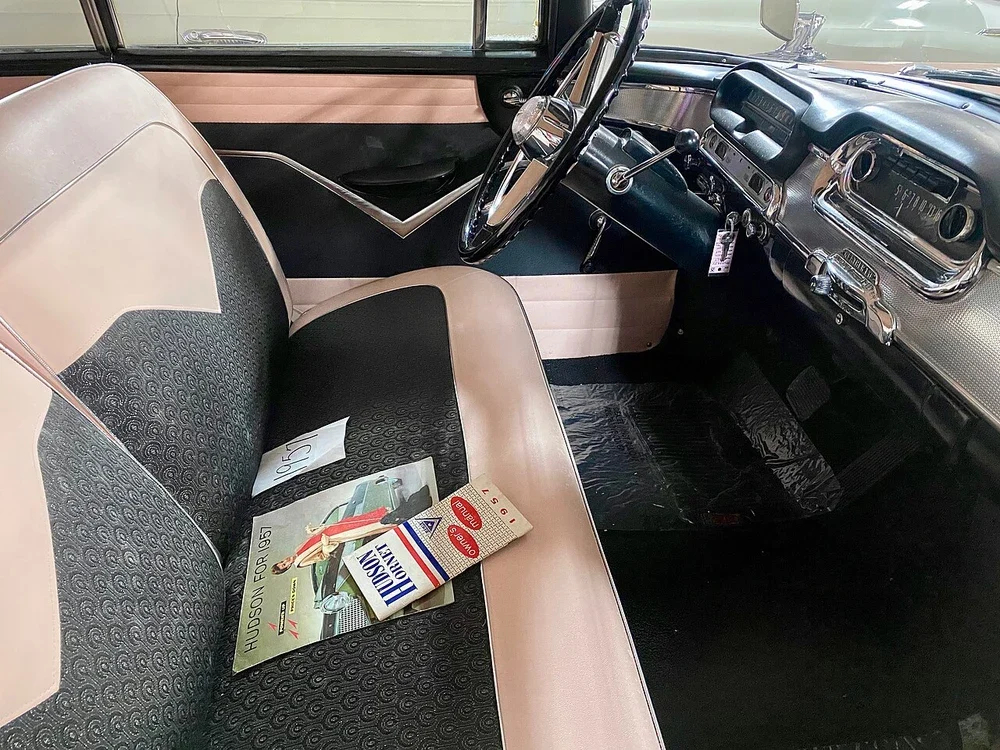 Two-tone seats and display literature inside a classic car
